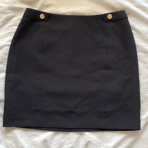 NWT Black mini skirt with faux gold button details in the front